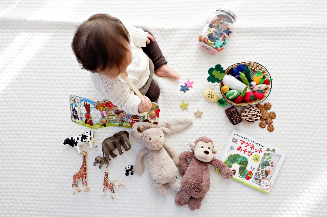 baby sitting by toys